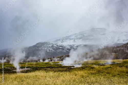Steam Rising from the Strokkur Geysir Field with Mountains in the Background