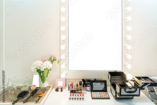 Modern closet room with make-up vanity table, mirror and cosmetics product in flat style house. photo
