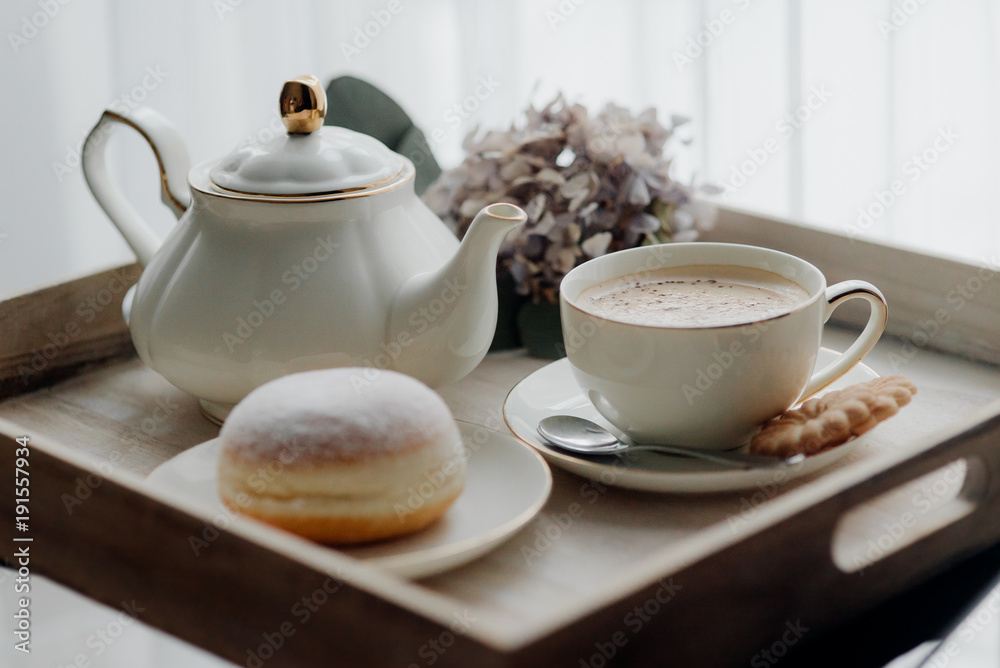 Fototapeta premium Donuts on plate on woode board with hot coffee for breakfast