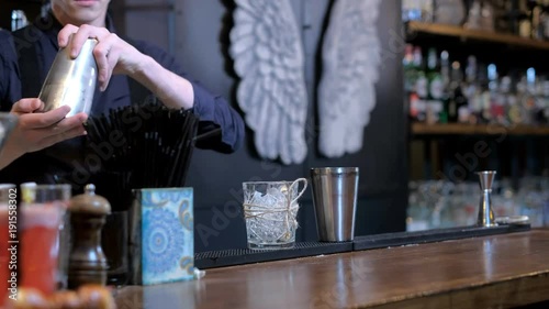 Expert barman is making cocktail at bar photo