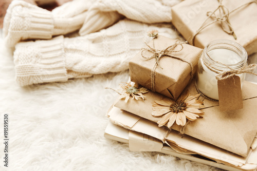 Vintage background . Cozy composition with gift box and warm sweater