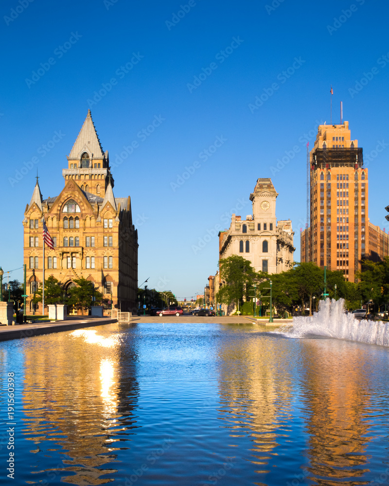Downtown Syracuse New York with view of historic buildings and fountain at Clinton Square Downtown Syracuse New York with view of historic buildings and fountain at Clinton Square