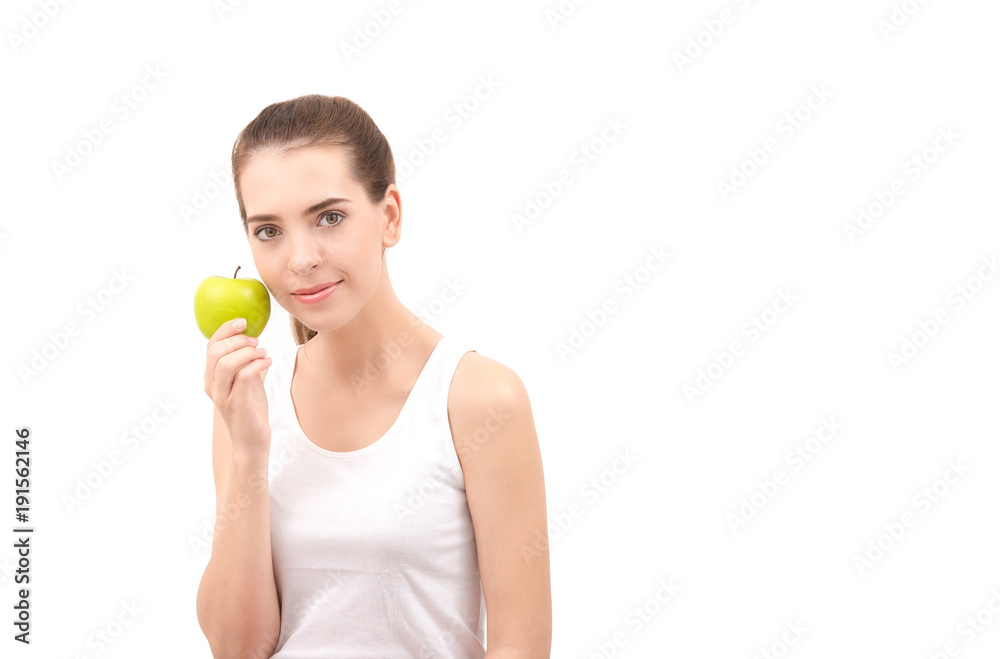 Carefree healthy hispanic woman cheerful confidence smiling and holding green apple . She wearing white undershirt isolated on white with copy space .Nutrition and health care concept . Carefree healthy hispanic woman cheerful confidence smiling and holding green apple . She wearing white undershirt isolated on white with copy space .Nutrition and health care concept .