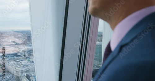 Wallpaper Mural 4K Successful London business manager looking out of window at view of the sprawling city landscape Torontodigital.ca