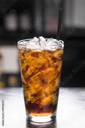 Iced Cola in tall glass, dark background