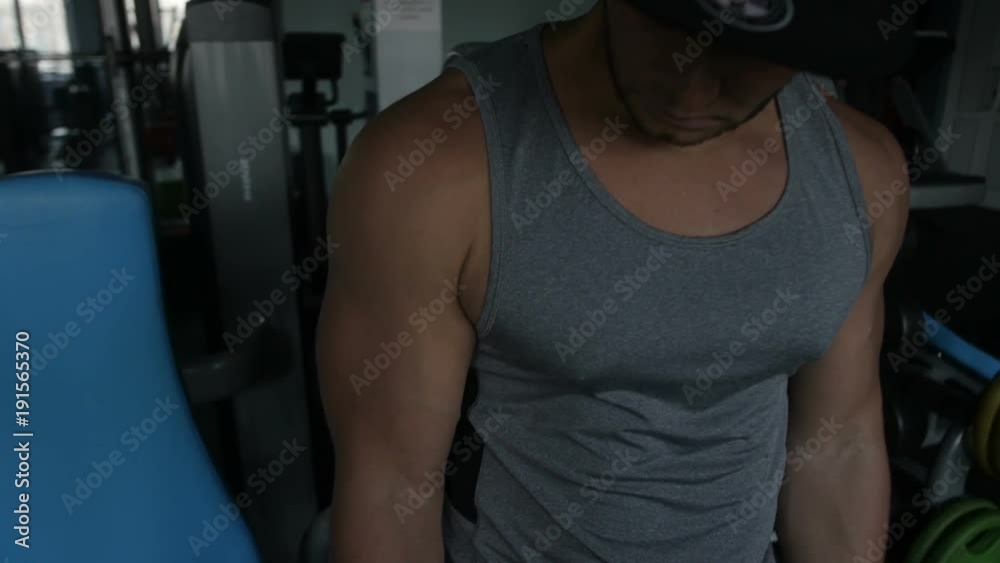 Bodybuilder is doing EZ barbell curl Bodybuilder is doing EZ barbell curl