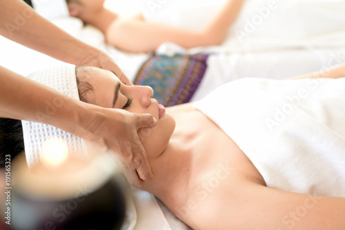 Young healthy asian woman lying relax in spa salon.Traditional Thai oriental aromatherapy and Massage beauty treatments.Recreation vitality wellness wellbeing  resort hotel lifestyle leisure.copyspace