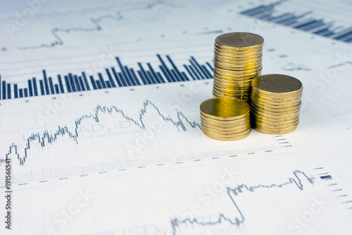 Personal saving, piles of gold coins on dollar bills,  supplementary pension concept closeup selective focus