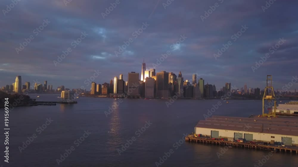 sunset flying backward from Manhattan view revealing crane on left sunset flying backward from Manhattan view revealing crane on left