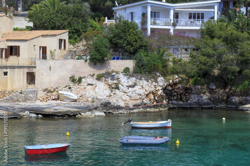 Europe, Spain, Balearic Islands, Mallorca, Santanyi, Cala Figuera . A small , colorful fishing harbor on S.E. corner of island. Sailboat anchoring. photo