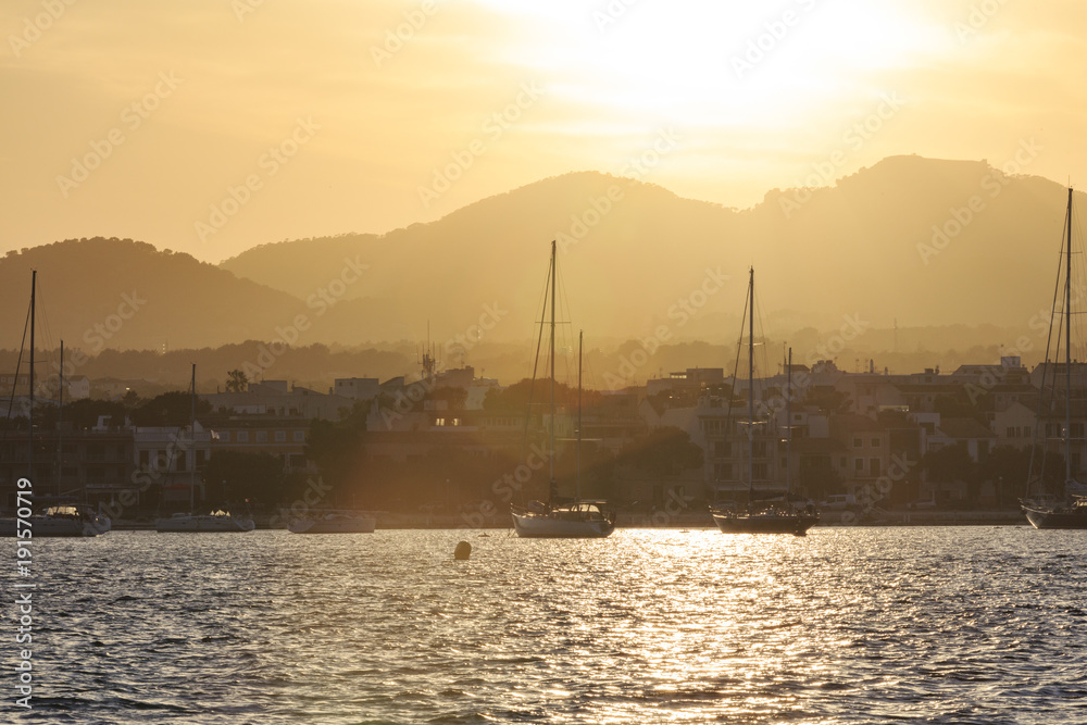 Europe, Spain, Balearic Islands, Mallorca. Porto Colom. Sailboats at sunset.