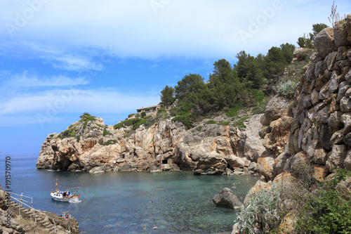 Europe, Spain, Balearic Islands, Mallorca. Cala Banyalbufar. Beachfront swimming. Harbor, Sunbathers. Boats.