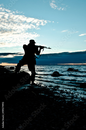 silhouette of a soldier aiming a rifle