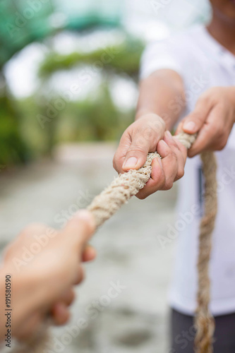 Hands pulling rope
