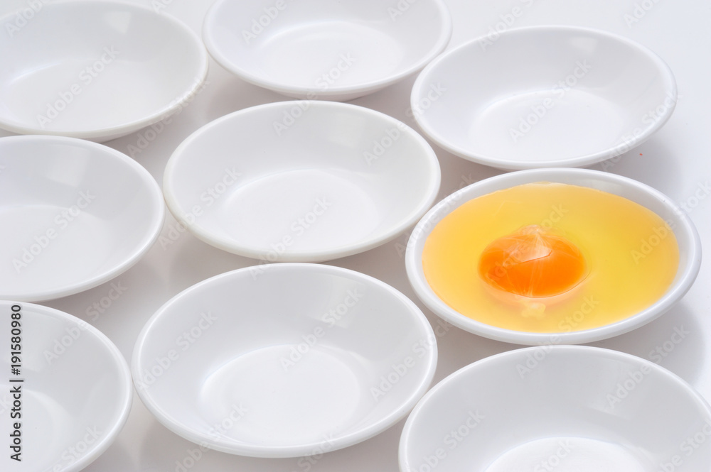 yolks in small bowls by circle shape repetition in white background. yolks in small bowls by circle shape repetition in white background.