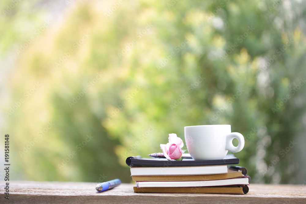 Soft pink pigmy rose with white cup and diary note Soft pink pigmy rose with white cup and diary note