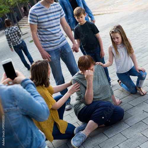 Relatives helping mature woman