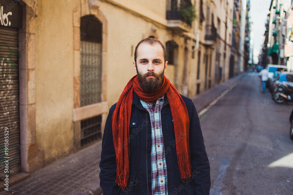 Casual bearded man in outerwear on street