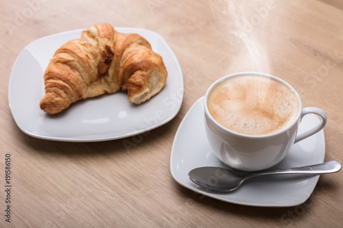 Fototapeta Naklejka Na Ścianę i Meble -  Croissant And Cup Of Coffee At Breakfast