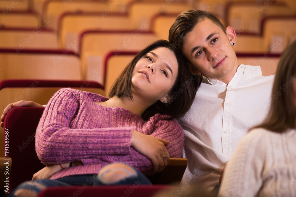 Loving young couple at date in cinema