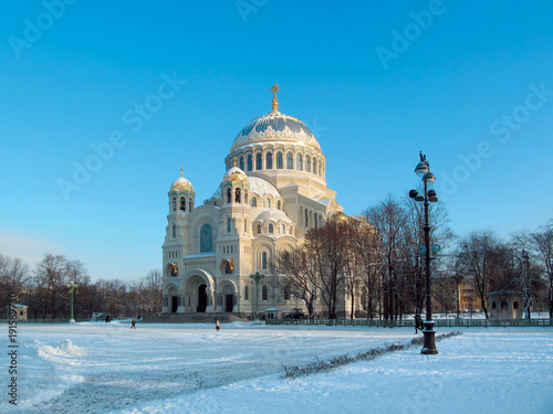 Winter skyline with Kronstadt Cathedral, facade with sunlight and blue sky. Naval Cathedral of St. Nicholas, Kronstadt, St. Petersburg, Russia.