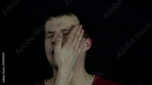 A young man gets in the face with a hand photo