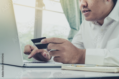 Young businessman use Credit Card to Shopping Online with Computer Laptop