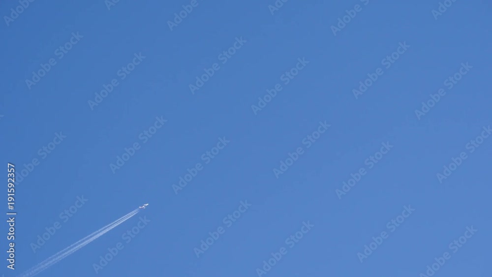Tokyo, Japan-December 12, 2017: An airplane departed from Haneda airport flies drawing a white contrail on a blue winter sky in Tokyo. Tokyo, Japan-December 12, 2017: An airplane departed from Haneda airport flies drawing a white contrail on a blue winter sky in Tokyo.
