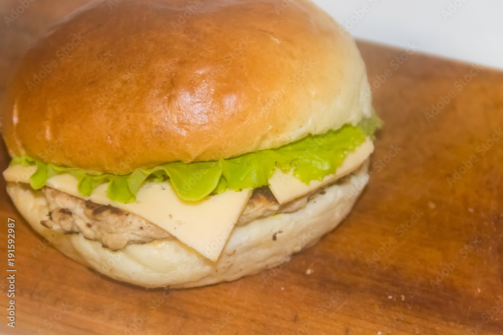 Fresh cheeseburger on wooden board Fresh cheeseburger on wooden board