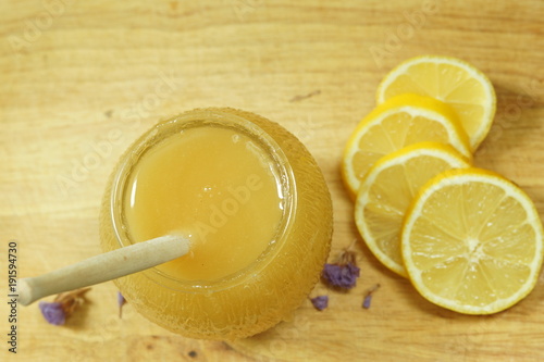 Top view of a barrel of honey and lemon, a popular medicine for colds