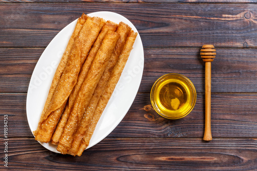 Hot pancakes with sprinkled maple syrup. The good you breakfast. top view photo