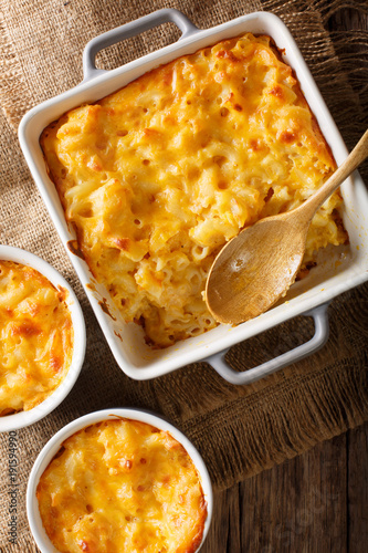 American casserole macaroni and cheese in baking dish close up. Vertical top view