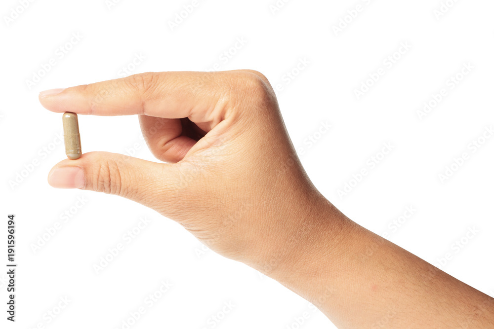 Hand with a pill herb isolated clipping path Hand with a pill herb isolated clipping path