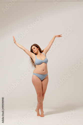 Overweight model in fashion underwear. Imitating dance.