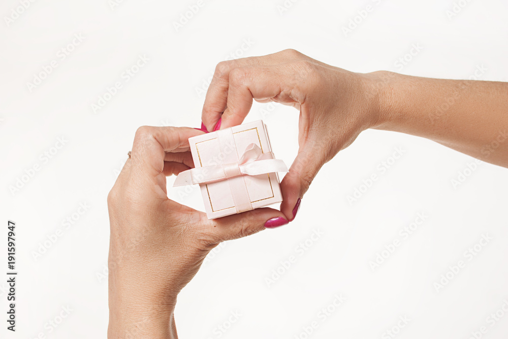 Female hands hold a pink little box. gestures with your hands. a heart Female hands hold a pink little box. gestures with your hands. a heart