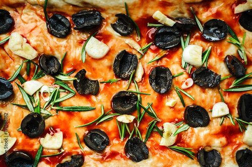 traditional Italian homemade focaccia with rosemary, olives and garlic