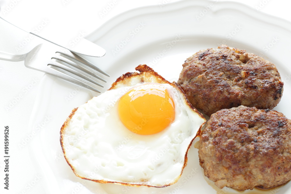 Sunny side up fried egg and patty Sunny side up fried egg and patty