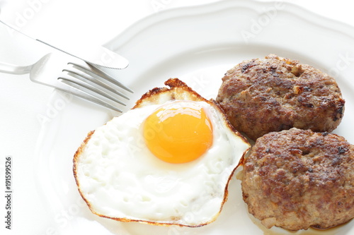 Sunny side up fried egg and patty photo