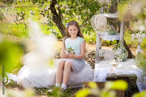 Beautiful young girl in spring garden photo