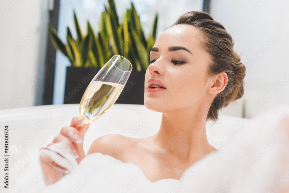 portrait of beautiful woman with glass of champagne taking bath portrait of beautiful woman with glass of champagne taking bath
