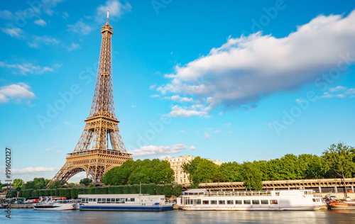 Eiffel tower and Seine river touristic boats, long exposure