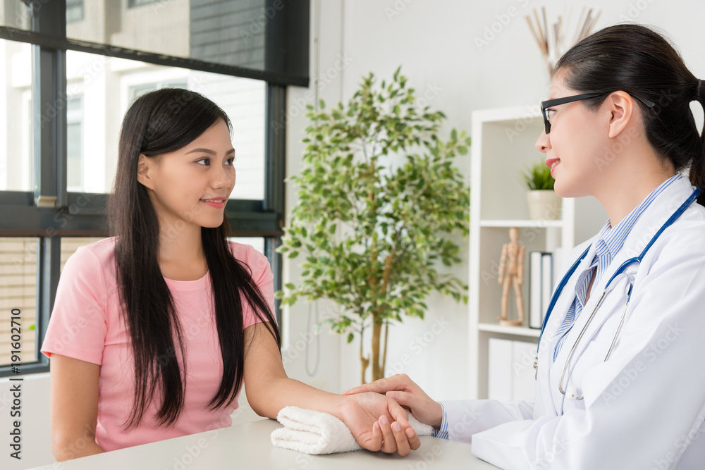 smiling pretty woman doctor touching patient hand smiling pretty woman doctor touching patient hand