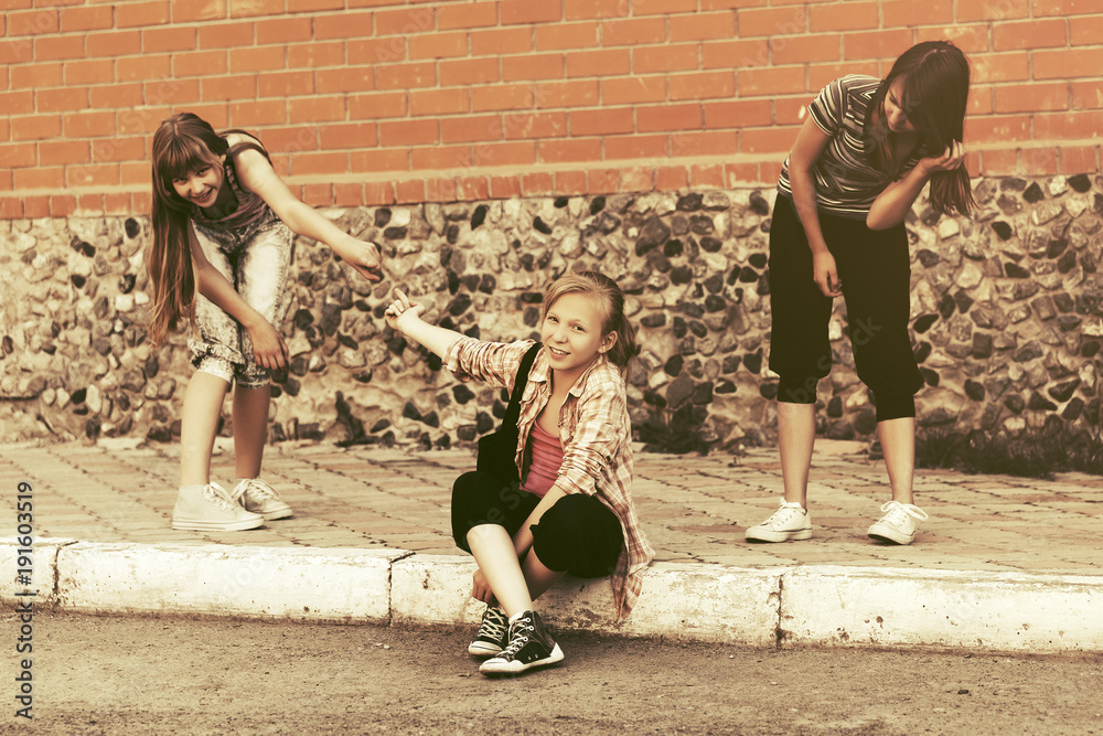 Group of happy teen girls having fun in city street Group of happy teen girls having fun in city street