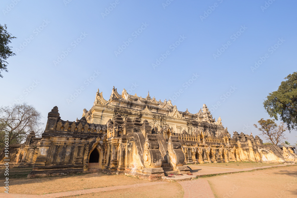 Maha Aungmye (Aung Mye) Bonzan monastery (also known asn Me Nu Ok Kyaung or Me Nu's Brick Monastery) in Inwa (Ava) near Mandalay in Myanmar (Burma). Copy space. Maha Aungmye (Aung Mye) Bonzan monastery (also known asn Me Nu Ok Kyaung or Me Nu's Brick Monastery) in Inwa (Ava) near Mandalay in Myanmar (Burma). Copy space.