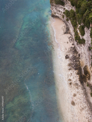 Aerial view of beach coastline on cliff side.