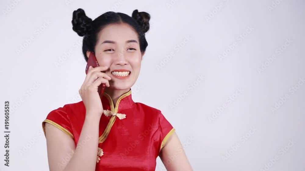 happy woman wear cheongsam and using mobile phone happy woman wear cheongsam and using mobile phone