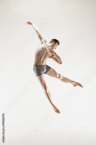 The male athletic ballet dancer performing dance isolated on white background. © master1305