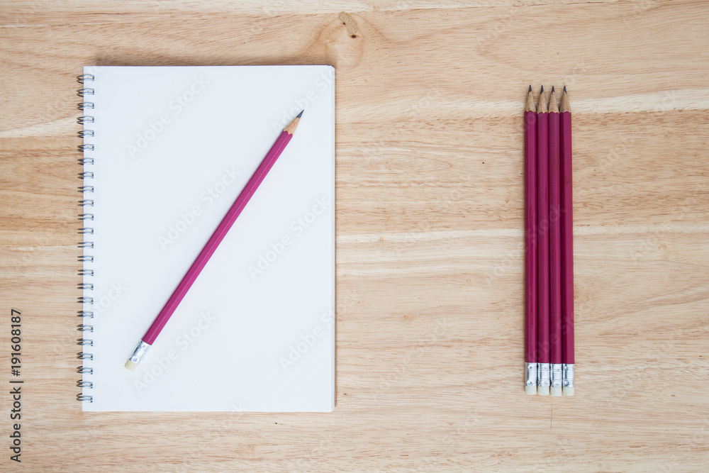 pencil and book on wood background pencil and book on wood background