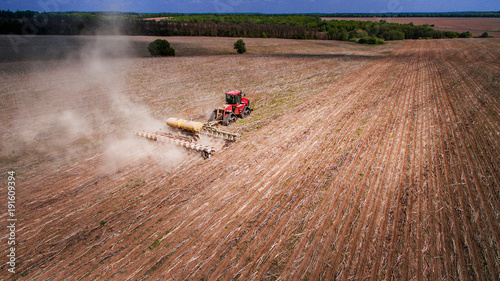 tractor preparing land for sowing sixteen rows aerial photo