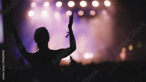 Slow motion concert fan dancing at life music concert